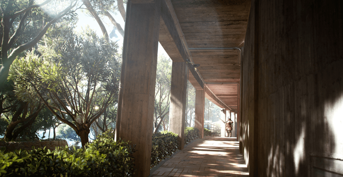 Person walking through forested glass corridor